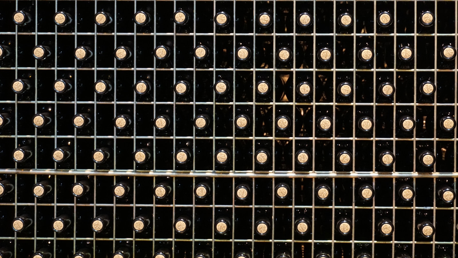 Wine bottles stored in a finished wine cellar for Where Should Wine Cellar Cooling Equipment Go?